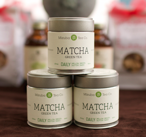 Three branded tins of Mizuba Matcha green tea