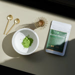 Koshun Matcha powder in a bowl next to a bag of matcha