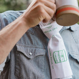 Man drinking tea wearing a Mizuba Tea Co. Tenugui