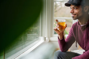 Man drinking kyobancha Japanese roasted tea and looks out the window