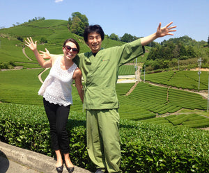 Woman and Man stand in tea field in Japan