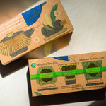 Two decorative tea boxes illustrated with a tea pot and tea cup on a light surface. The lower box reads 'Mizuba Tea Co. and features three ceremonial matcha teas: Tsuyuhikari, Shirakawa, and Yorokobi Matcha.