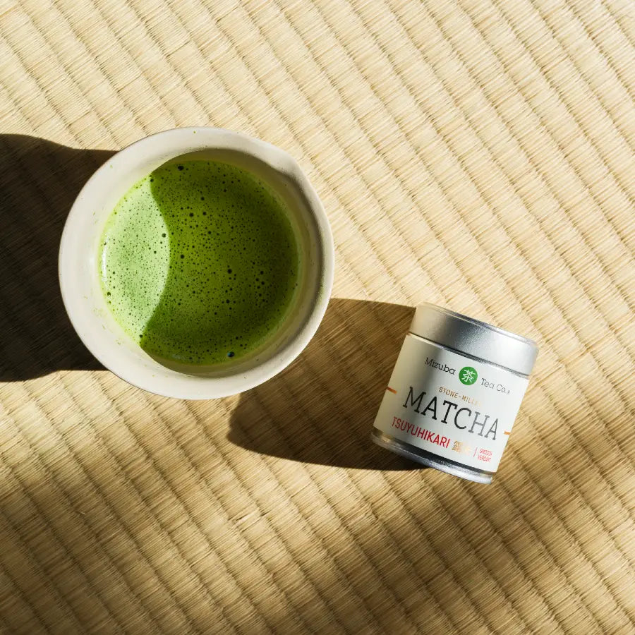 Tsuyuhikari matcha tin  next to brewed matcha