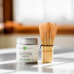 Mizuba Matcha Essentials Bundle featuring a 30 serving tin of matcha and hand carved bamboo whisk.