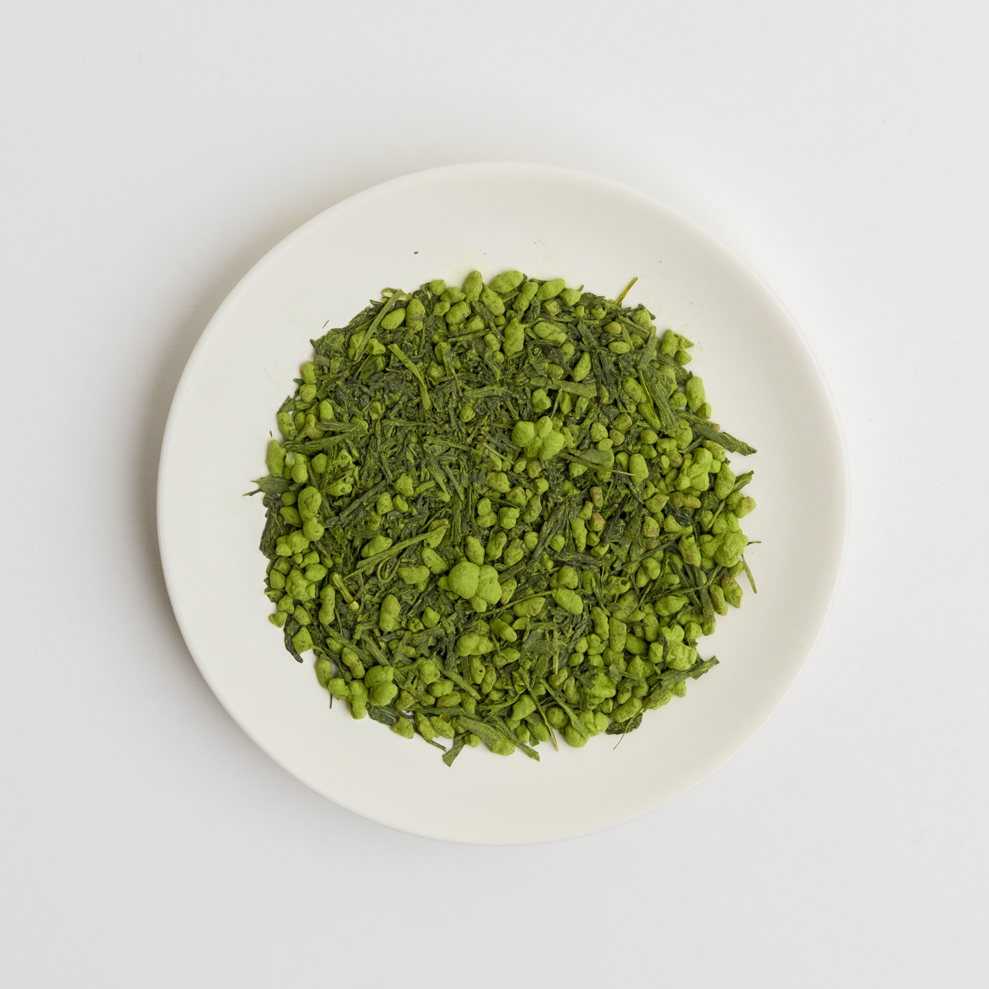 Japanese Organic Matcha Covered Genmaicha Loose Leaf Green Tea on a white plate