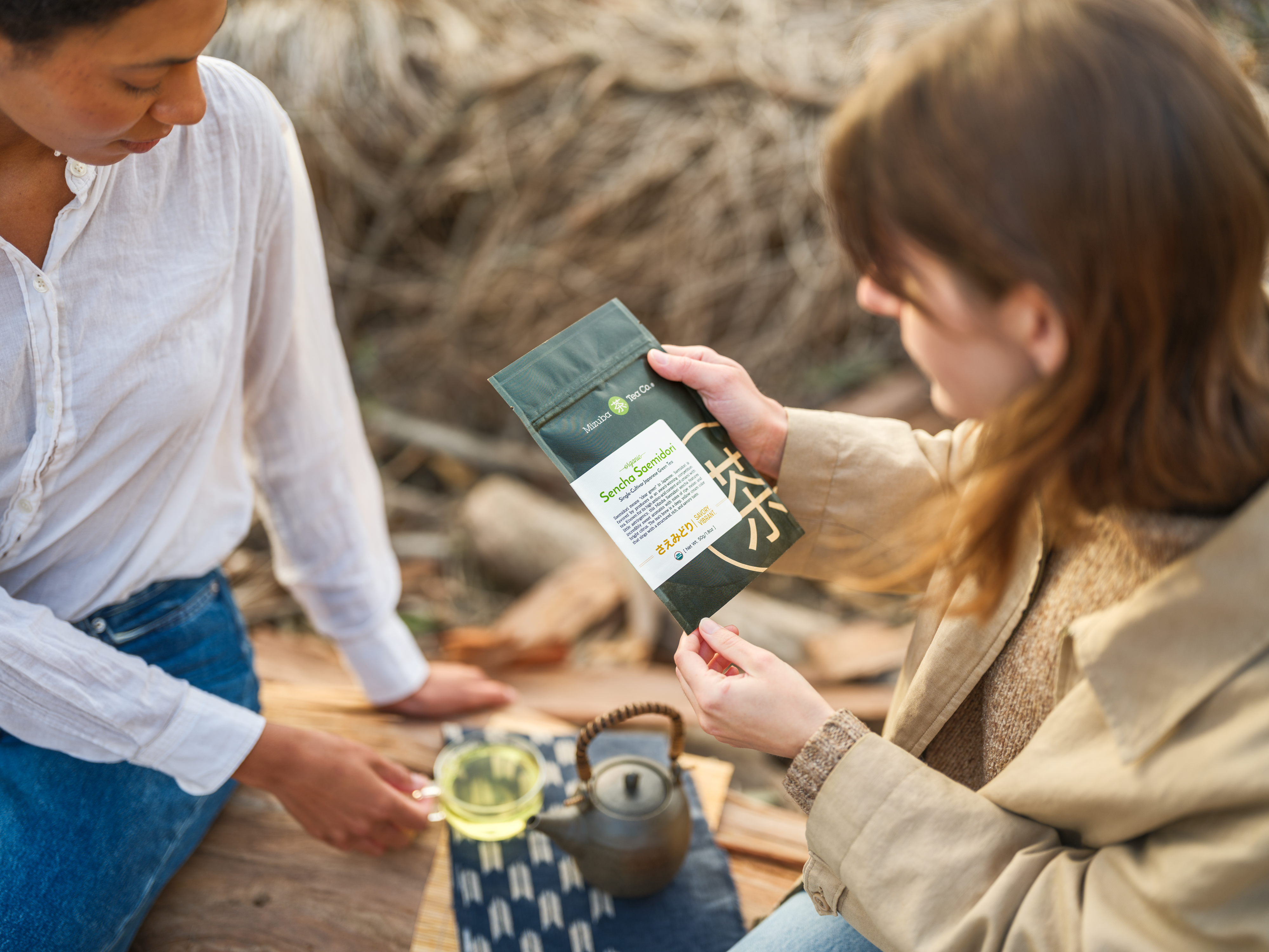 Two women enjoying Mizuba sencha Japanese tea in the outdoors.