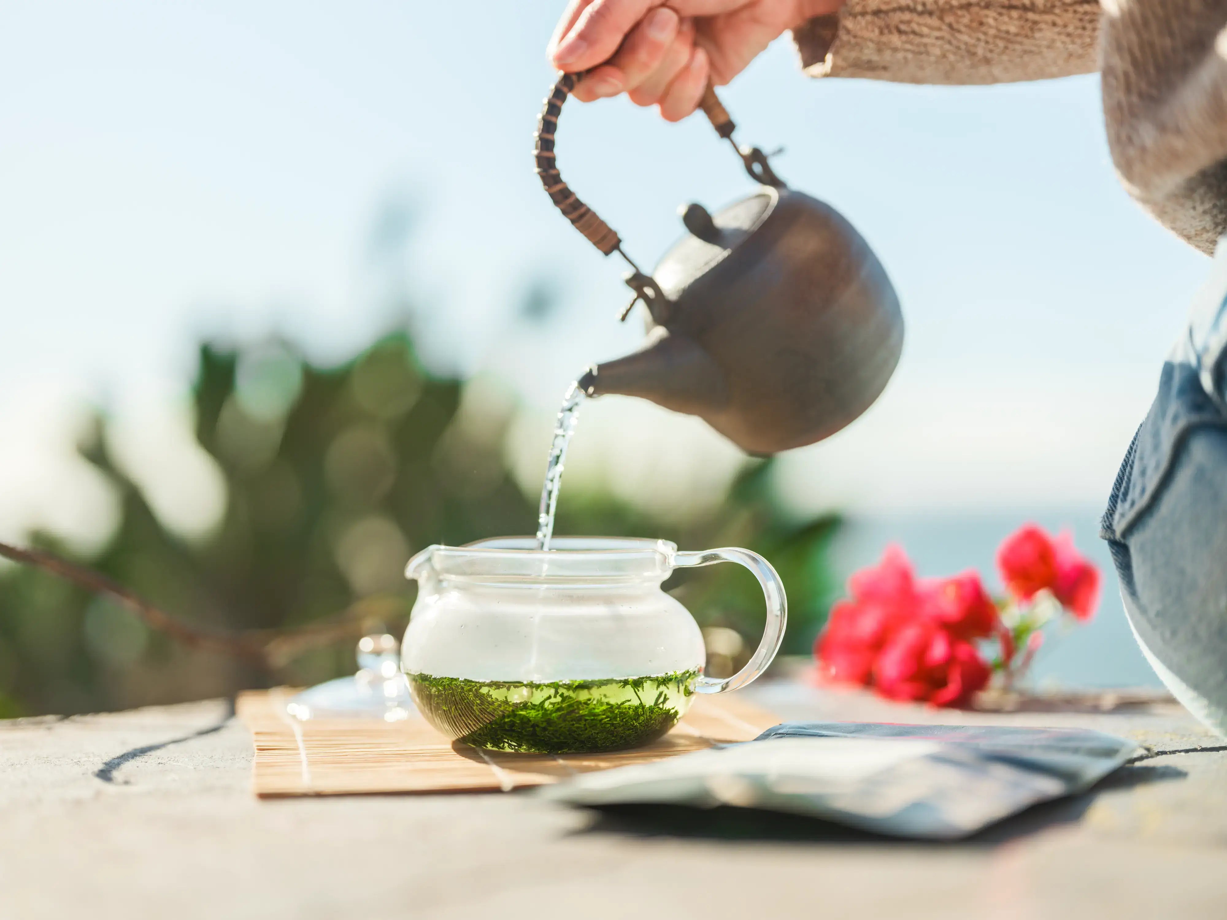 Pouring teapot to steep green tea