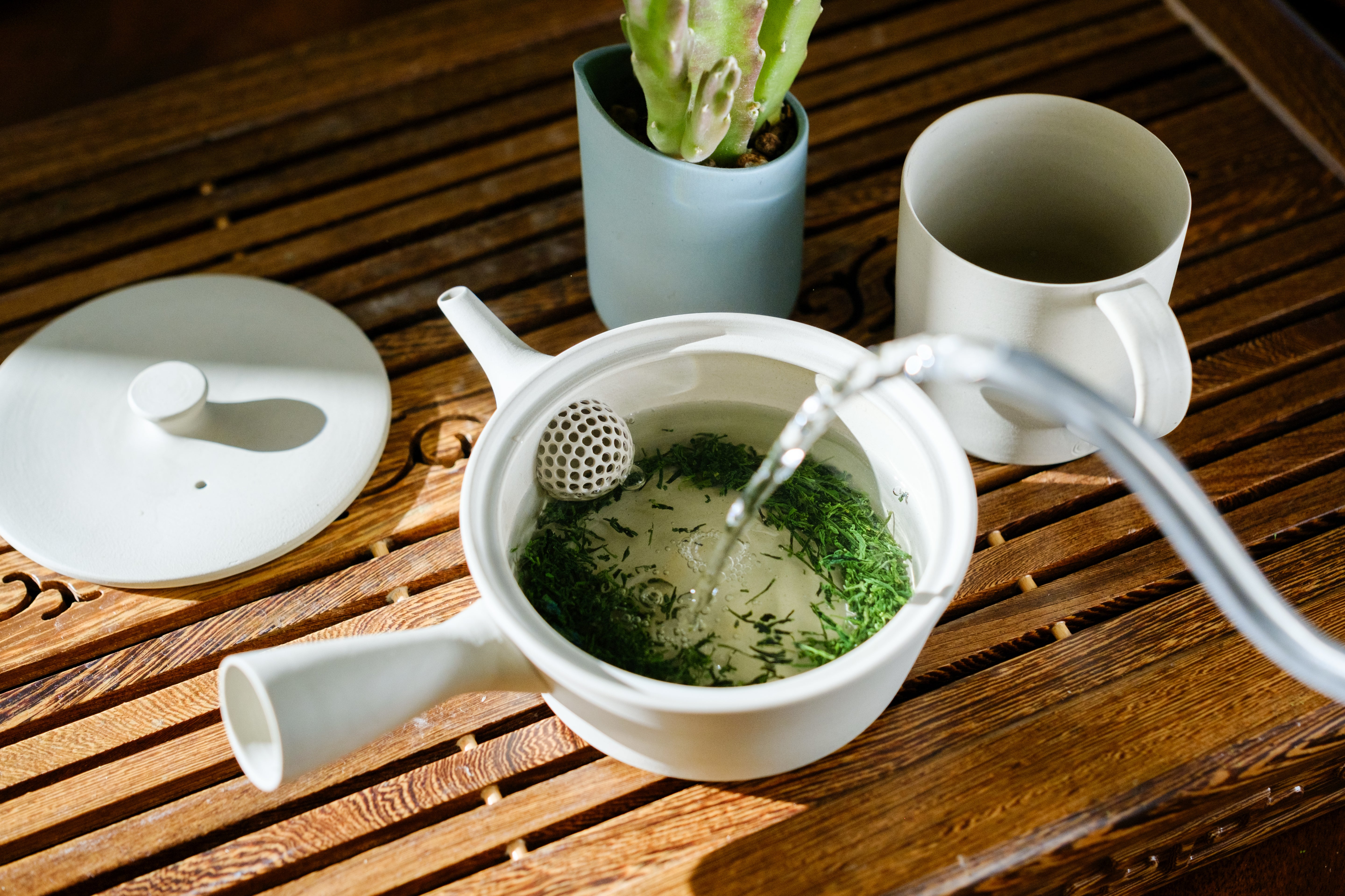 Sencha brewing in a handmade, Japanese ceramic Kyusu from Nankei - Mizuba Tea Co.