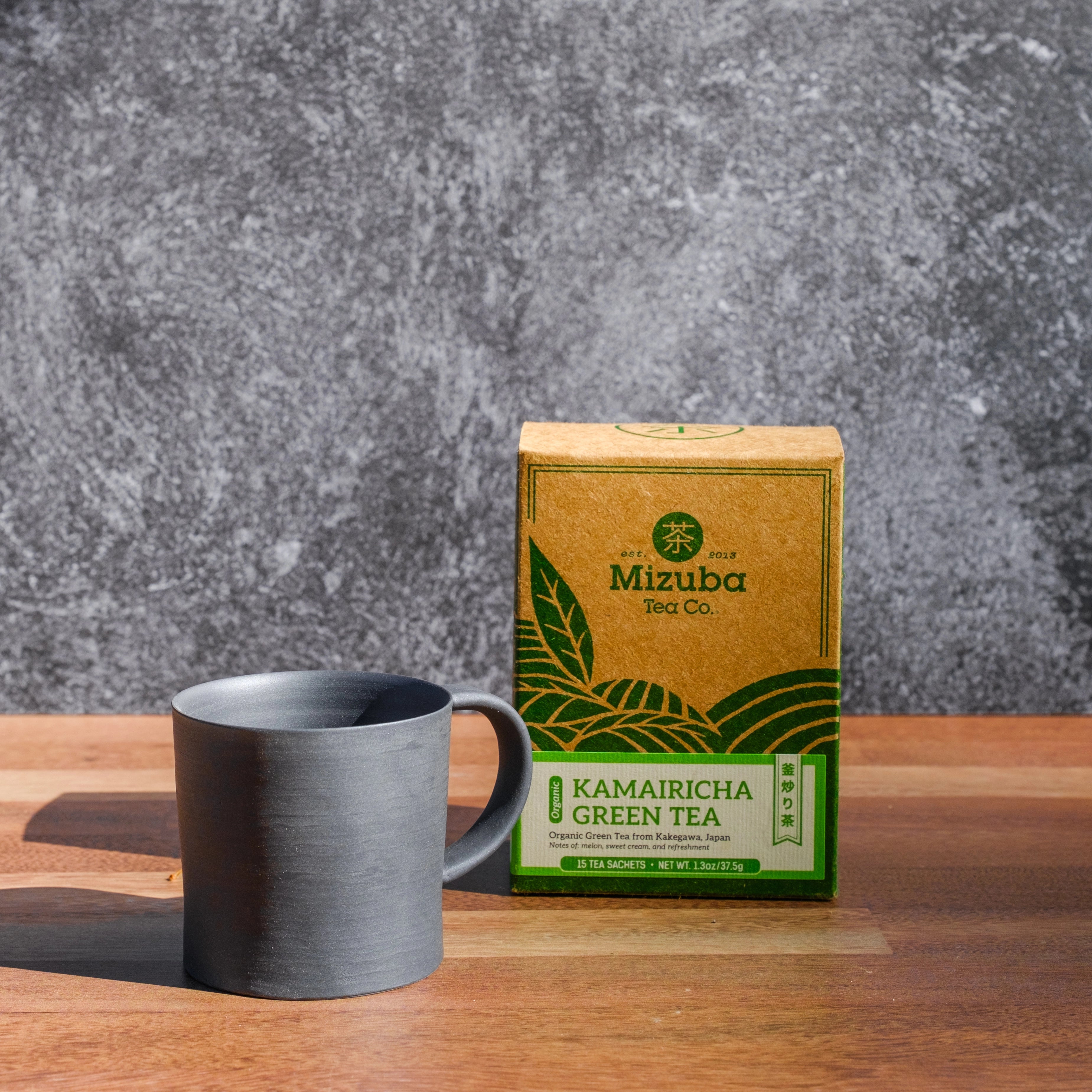 Matte black ceramic mug with Kamairicha sencha Japanese green tea bags - Mizuba Tea Co.