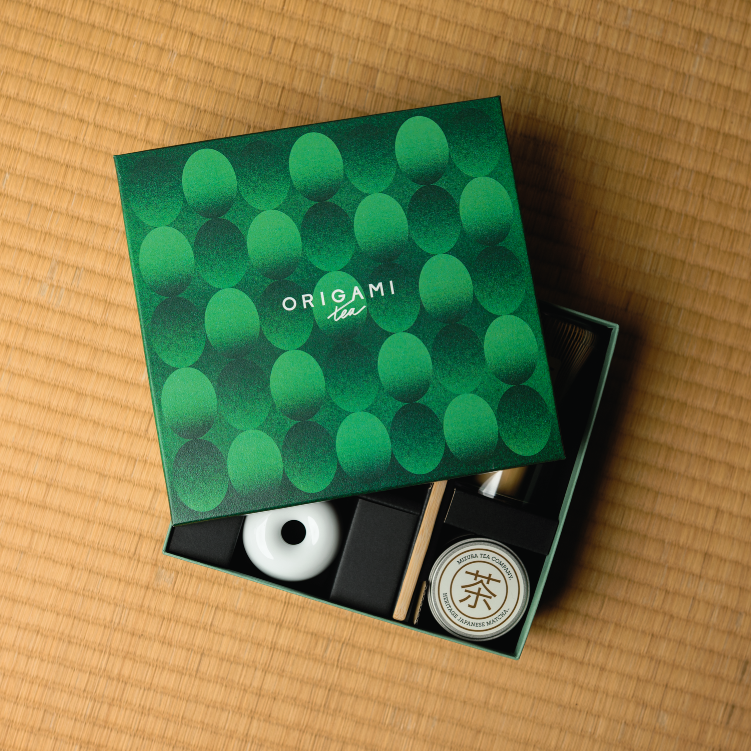 Origami Tea packaging with green pattern on a tatami mat surface