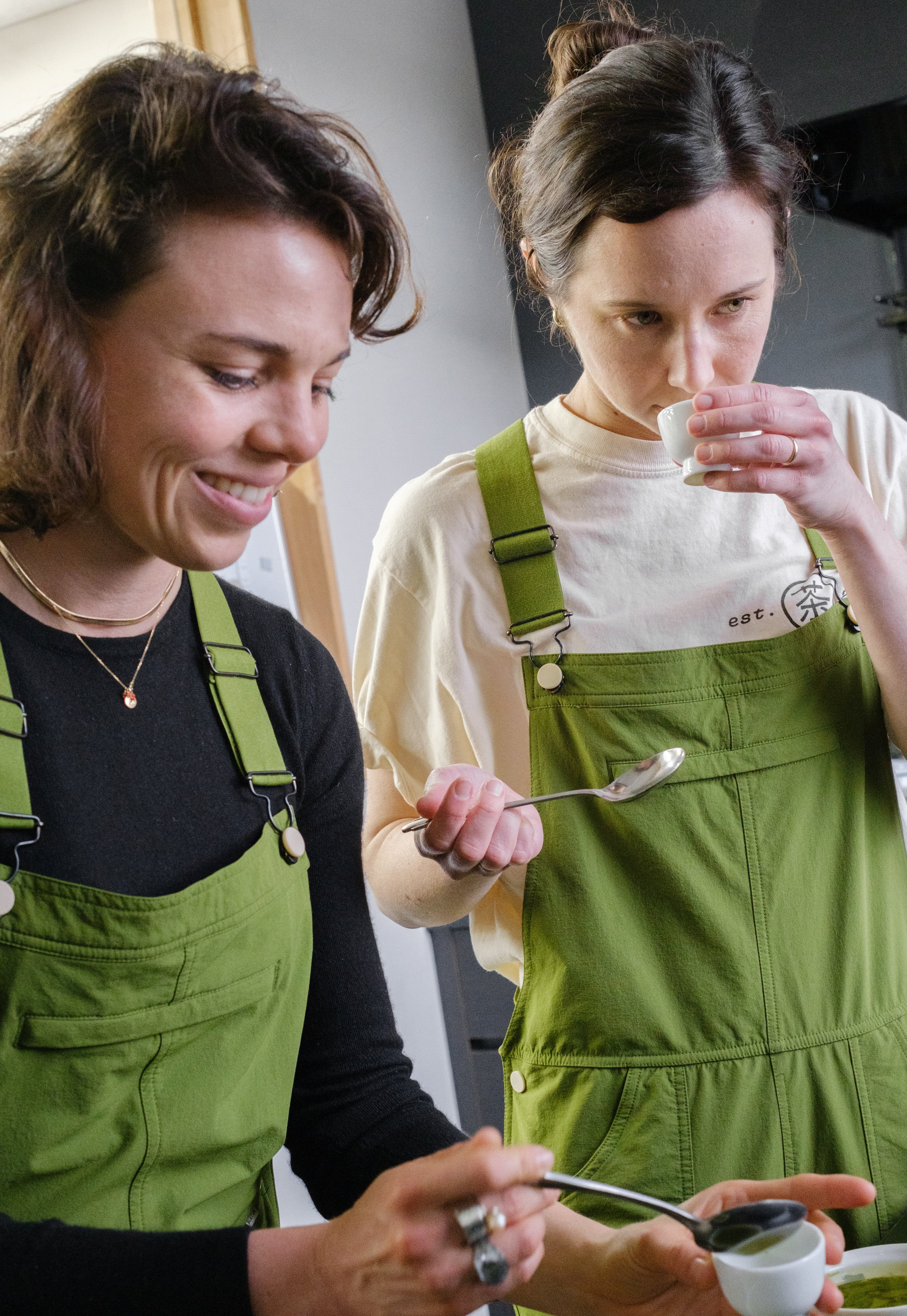 Two women from Mizuba Tea Co. evaluate  Japanese tea