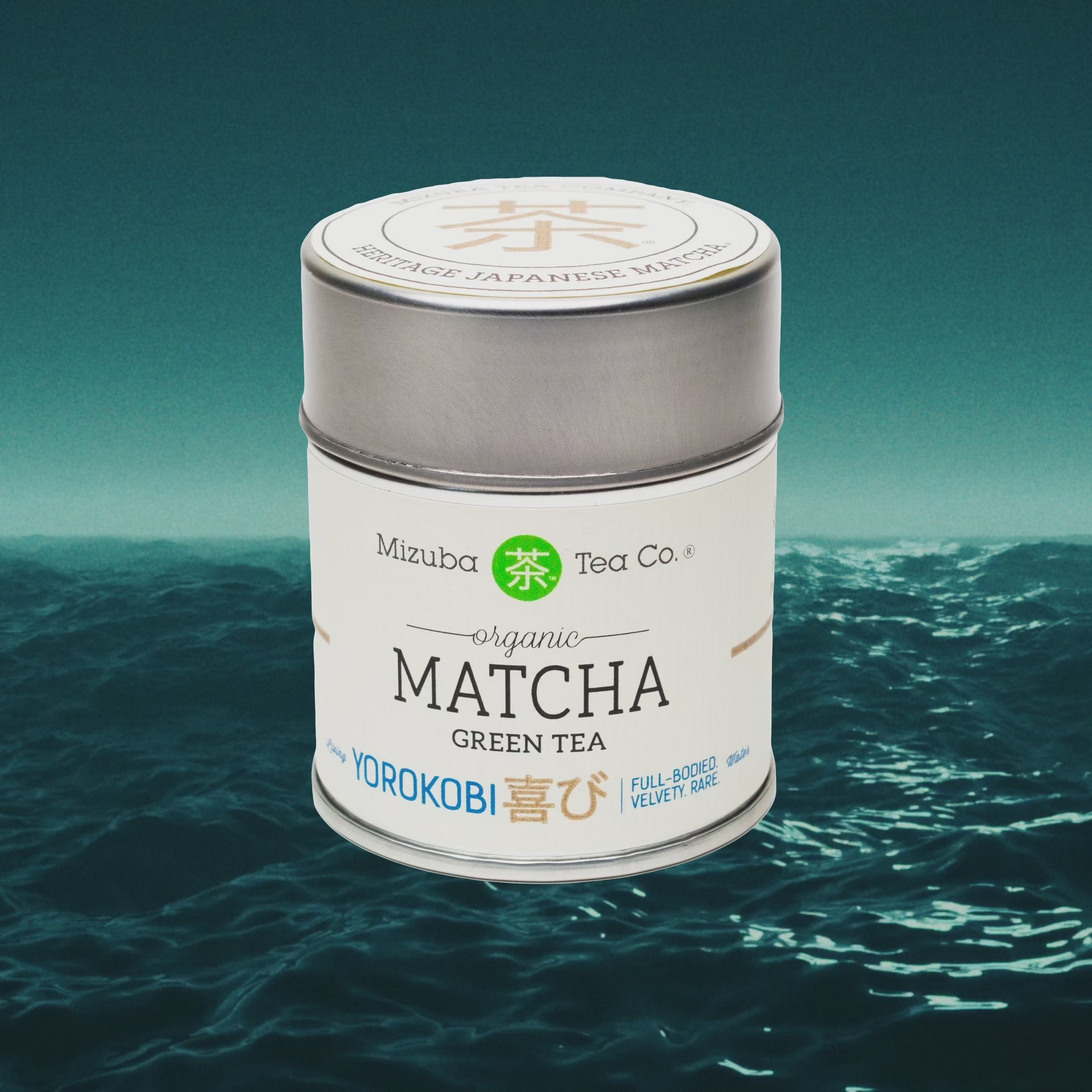 A tin of organic Yorokobi ceremonial matcha green tea superimposed on an ocean seascape video - Mizuba Tea Co.