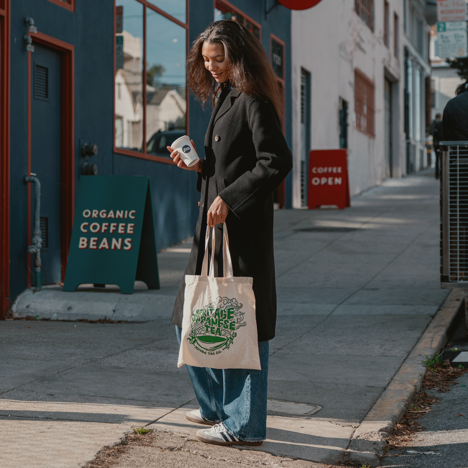 Woman holding Mizuba Tea Canvas bag