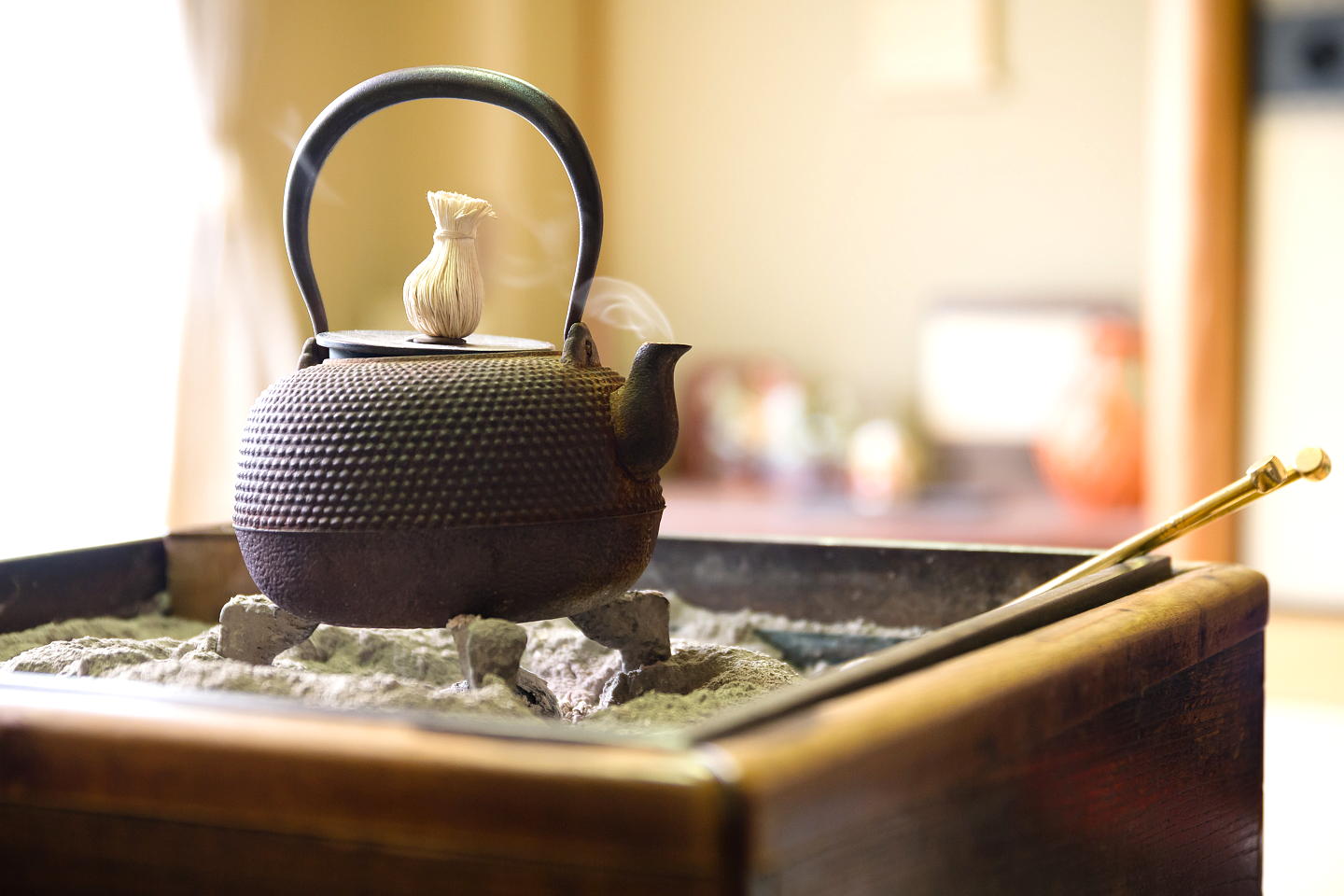 An iron tea kettle heats over a charcoal stove in Kyoto, Japan. 