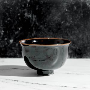 Black porcelain chawan matcha tea bowl on a table